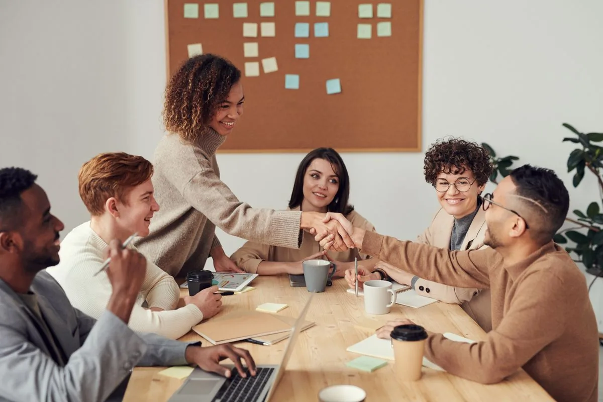 Adults collaborating around a table in a bright workspace